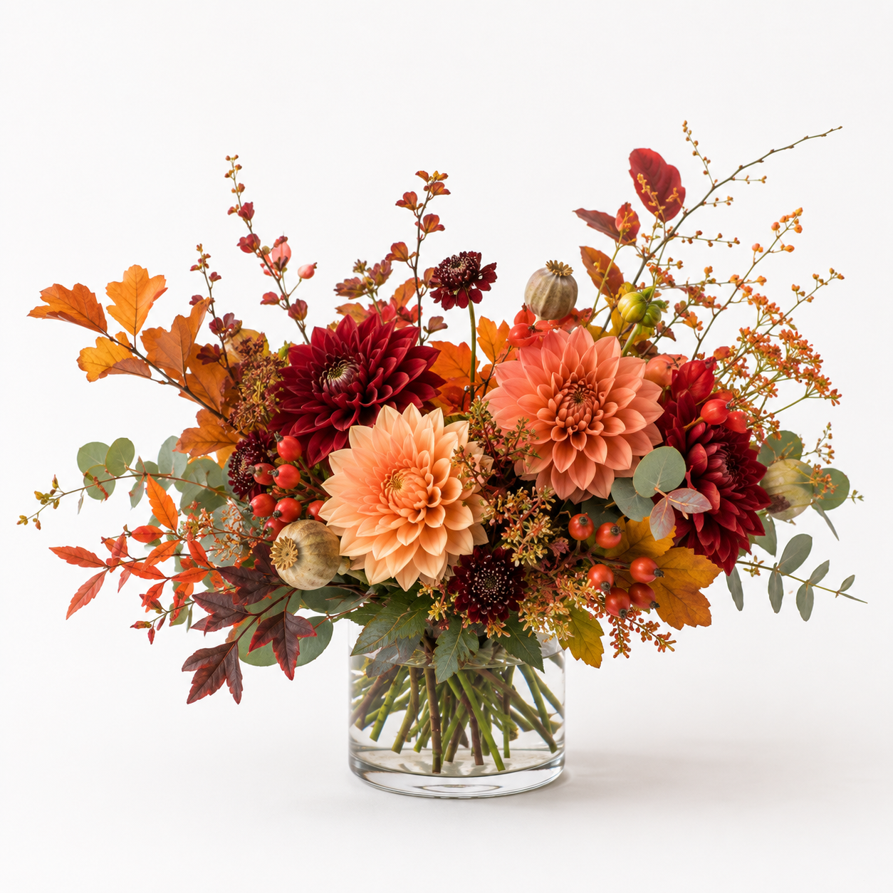 Warm-toned autumn vase arrangement with dahlias and foliage